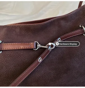 Detail of vintage brown tote bag showing silver metal lobster clasp and stitching
