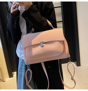 Pink matte crossbody bag detail with silver metal clasp and refined leather texture