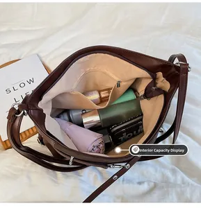Interior view showing the large capacity and zipper pocket of the brown leather tote bag