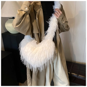 Detail of soft white faux fur heart bag texture on a shoulder strap for women