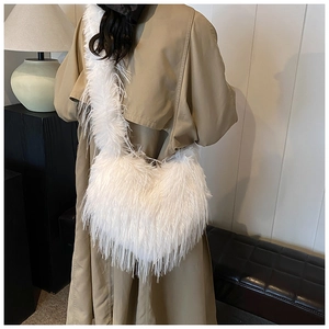 Close-up of white plush crossbody bag with soft faux fur texture and matching shoulder strap