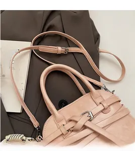 Detailed close-up of the adjustable strap and belt buckle detail on a pink shell bag