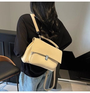 Detail of cream matte satchel with silver twist lock and adjustable shoulder strap