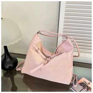 Detail of pink leather hobo bag with silver hardware and adjustable strap accents