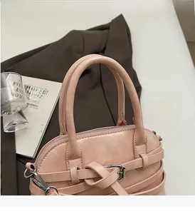 Pink faux leather shoulder bag with decorative buckle and silver hardware detail