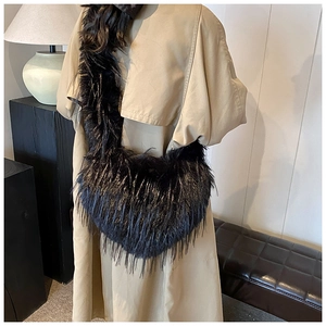 Close-up of black faux fur tote bag showing the fluffy texture and plush finish on a model