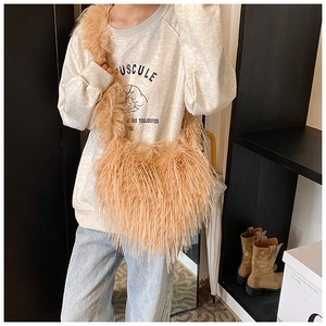 Detailed view of camel faux fur shoulder bag texture shown on model in indoor setting