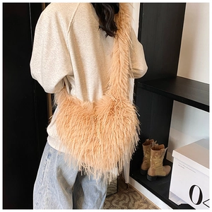 Detail shot of the peach fuzzy plush crossbody bag showing the soft feathery texture
