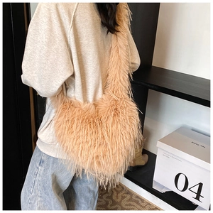 Detail showing plush faux fur texture on a pink crossbody bag for women with wide strap