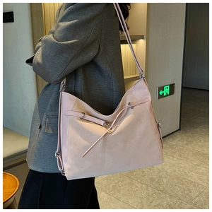 Detailed side view of a large light pink tote bag featuring a premium pebbled leather texture