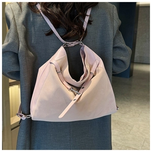 Detail showing pink suede and leather patchwork material on stylish women's backpack