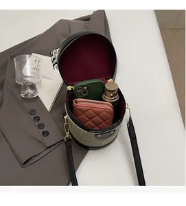 Interior view of drum-shaped crossbody bag showing spacious capacity for daily items