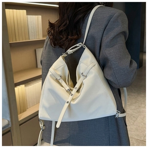Detail view of cream white minimalist PU leather tote bag with silver ring and strap texture