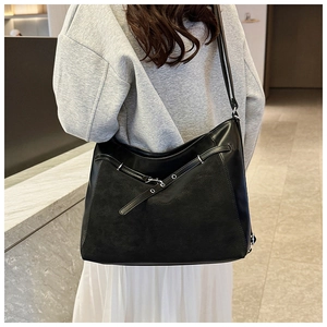 Close-up of black large capacity hobo bag with silver buckle details on soft PU leather