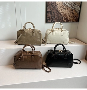 Detail view of leather Boston bags in four colors with dual handles and metal zippers
