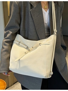 Chic cream white PU leather tote bag with stylish crisscross straps and metal hardware