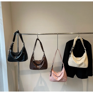 Detail view of large hobo bags in four colors with smooth retro leather and metal charms