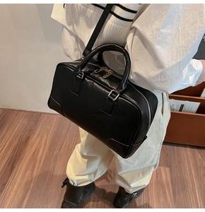 Close-up of a black matte bowling bag with reinforced corners and silver hardware detail
