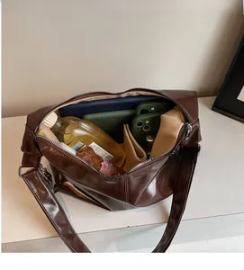 Macro view of spacious interior in shiny dark brown tote bag with zipper closure