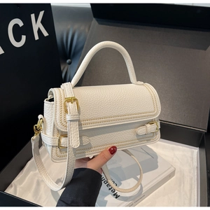 Top view of white pebble leather handbag with gold hardware and wavy stitching detail