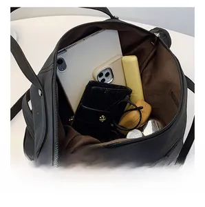 Detailed interior view of a large black tote bag showing spacious compartments and storage