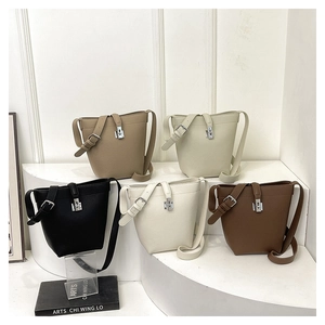 Detailed view of five color options for litchi pattern bucket bags with silver clasps