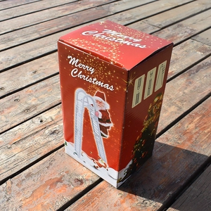 Detail view of the red Merry Christmas packaging showing ladder assembly steps for the toy