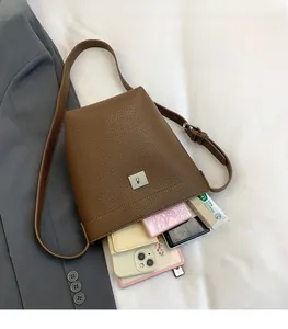 Brown lychee leather bucket bag showing large interior space for daily essentials