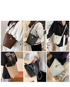 Litchi pattern bucket bag showing belt closure and metal lock detail on models
