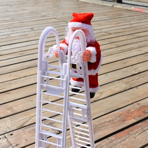Detail of electric Santa Claus toy climbing white ladder on outdoor wooden floor