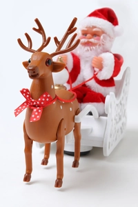 Detail view of electric Santa Claus on a white sleigh with reindeer Christmas toy decoration