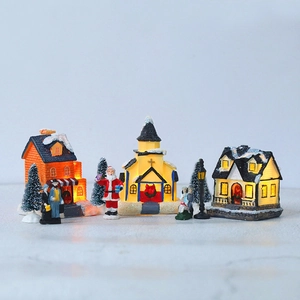 LED lighted Christmas village set with snowy houses, Santa, trees and street lamps