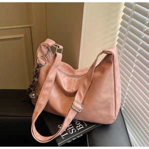 Detail of adjustable strap and silver buckle on dusty rose leather tote bag