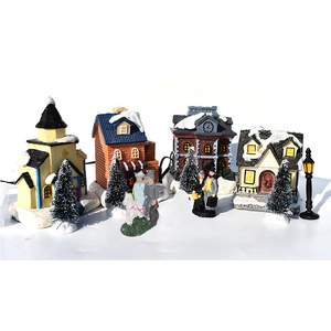 Detailed 11-piece LED Christmas village set with resin houses, trees, and winter figures
