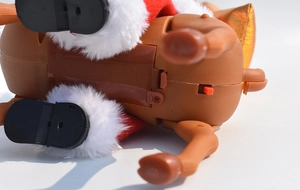 Close-up of the battery compartment and power switch on the musical Santa toy base