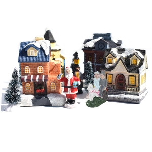 LED Christmas Village Set with snowy miniature houses, Santa figurine, and horse carriage