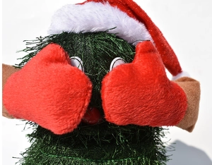 Macro shot of an electric dancing Christmas tree plush with red gloves and white background