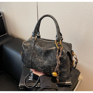 Detail of vintage black textured leather Boston bag with embossed COL TIME letters