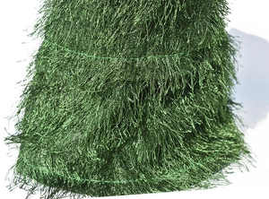 Macro view of green metallic fringe layers on a rotating electric Christmas decoration