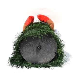 Detailed bottom view of the rotating Christmas tree toy showing the black plastic base