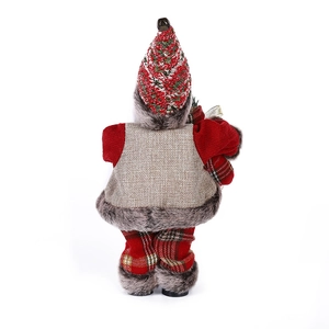Rear view of standing Santa figurine in plaid pants and plush vest for Christmas decor