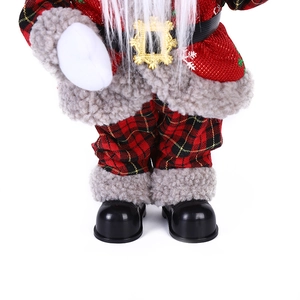 Detail of Santa figurine showing red silk coat, plaid pants and golden belt buckle