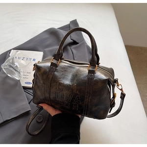Detail of vintage oil wax leather boston bag with embossed SOL TIVA TOR lettering