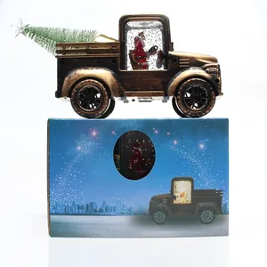 Detail of bronze Christmas tractor lantern with Santa and tree on a starry gift box