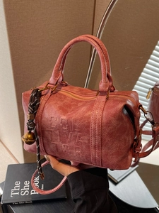 Retro brick red Boston handbag with Solve The embossing and decorative pendants