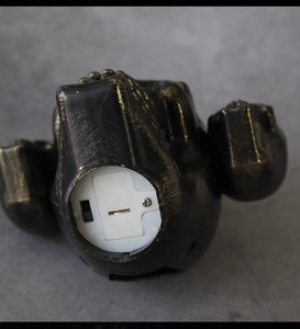 Detail view of the bottom power switch and LR44 battery compartment on LED skull lamp