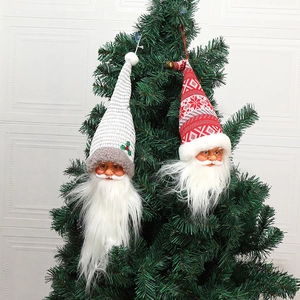 Christmas Santa Claus and snowman wine bottle covers hanging on a festive Christmas tree