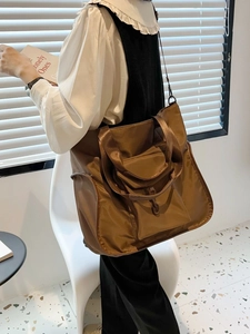 Brown nylon tote bag for women featuring a front flap pocket and spacious interior