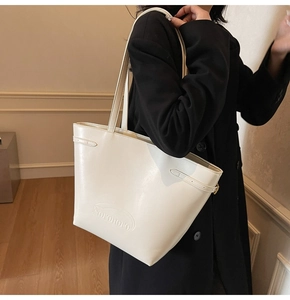 Detail of cream tote bag with embossed Noronoro logo and adjustable side strap