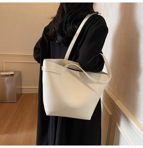Detail of large beige tote bag with Noronoro embossed text on premium matte leather
